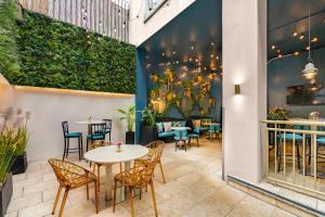 a patio with tables and chairs in a restaurant at The Morgan Hotel in Dublin