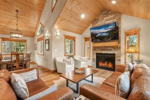 a living room with a couch and a fireplace at Northstar Resort by Vail Resorts in Truckee