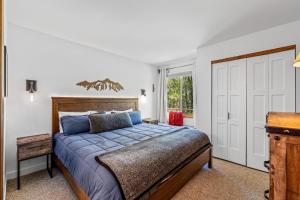 a bedroom with a bed and a desk and a window at Chickadee in Clark +36 photos
