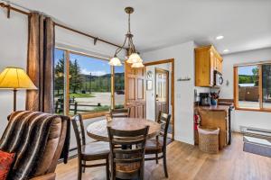 a kitchen and dining room with a table and chairs at Chickadee in Clark