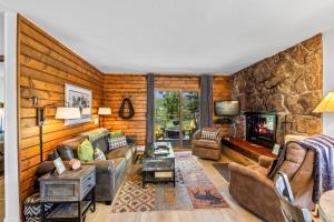a living room with a stone wall at Chickadee in Clark