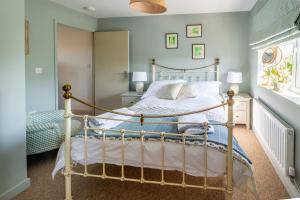 a bedroom with a bed and a window at Little Tern in Brancaster