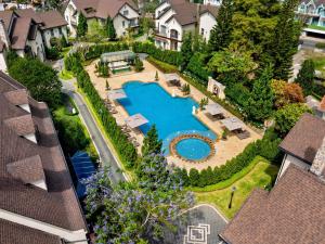 an aerial view of a house with a swimming pool at Grand Mercure Dalat in Da Lat
