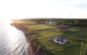 an aerial view of a house next to the water at Waterfront & breathtaking view - Chalet du Phare in Bonaventure
