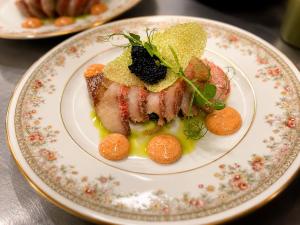 a plate of food with meat and vegetables on it at Burghotel Volmarstein in Wetter +9 photos
