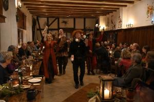 a group of people walking down a hall in a restaurant at Burghotel Volmarstein in Wetter