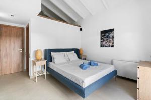 a bedroom with a bed with blue teddy bears on it at Ιπποθόη in Meganisi +14 photos