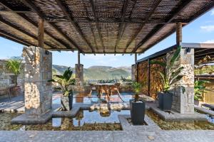 an outdoor patio with a table and chairs at Ιπποθόη in Meganisi