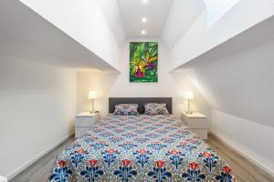a bedroom with a bed with a painting on the wall at Ferienwohnung Casa Marco 1 in Grenzach-Wyhlen