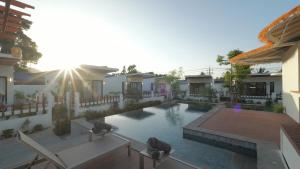 a swimming pool in the middle of a house at Pukawa Hotel & Residence in Chaloklum