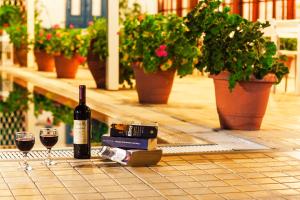 a bottle of wine and two glasses on a table at Stellina Hotel in Skiathos