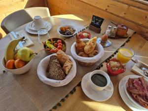 a table with a bunch of breakfast foods on it at Hôtel Le Jeu de Paume in Chamonix