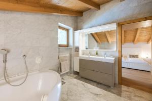 a bathroom with a tub and a sink and a bath tub at Villa in Cermes +19 photos