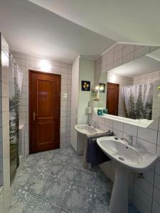 a bathroom with two sinks and a large mirror at Lila Central Apartman in Balatonlelle