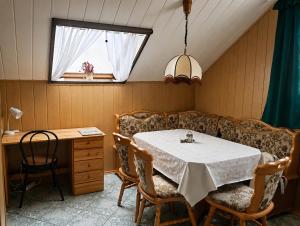 a dining room with a table and chairs and a window at Lila Central Apartman in Balatonlelle +15 photos