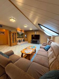 a living room with a couch and a table at Lila Central Apartman in Balatonlelle