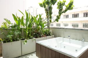 a bath tub on a balcony with plants at AN Studio VVT in Ho Chi Minh City +33 photos
