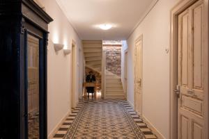 a hallway of a house with a tile floor and stairs at La Belle Hélène de Ménélas 1862 in Mykines
