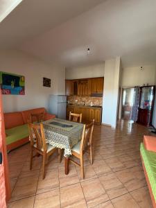 a kitchen and dining room with a table and chairs at Apartament Golem in Golem