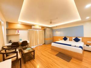 a hotel room with a bed and a desk at Durene Beach Resort - New Premium Resort In Baliapanda - Restaurant - Beach - Parking in Puri