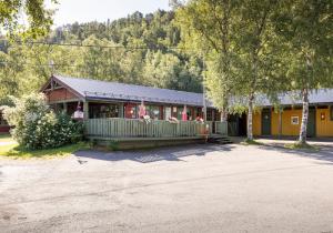a building with a porch with people in it at Fauske Camping & Motel in Fauske
