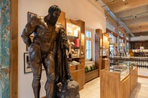 a statue of a man in a store lobby at La Belle Hélène de Ménélas 1862 in Mykines