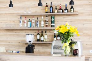 a counter with a vase of flowers and bottles of wine at Hotel Gullfoss in Haukadalur