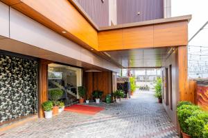 a lobby of a building with potted plants at FLY VIEW Airport Residency in Nedumbassery