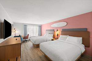 a hotel room with two beds and a desk at Hampton Inn San Simeon Cambria in San Simeon +56 photos