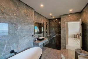 a bathroom with a tub and a sink and a shower at Apartment 24 in Durban