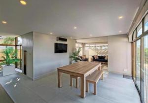 a living room with a wooden table and a couch at Apartment 24 in Durban