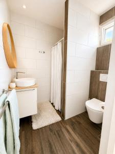 a bathroom with a sink and a toilet at Luxury Suites Oosterwold in Almere +20 photos