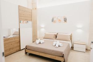 a bedroom with a bed with towels on it at Le Volte in Lizzano