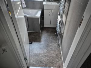 a bathroom with a sink and a toilet and a mirror at 2 double bedroom house 20mins walk to Durham city centre in Gilesgate