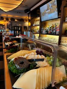 a buffet line with cheese and other food items at Hotel-Restaurant Amadeus in Hannover