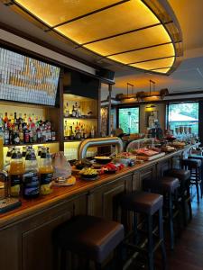 a bar with a lot of food and drinks at Hotel-Restaurant Amadeus in Hannover