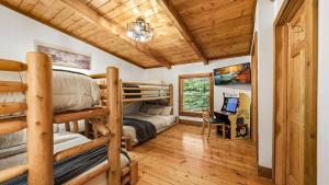 a bedroom with bunk beds and a desk at Hillside Hideaway in Sevierville