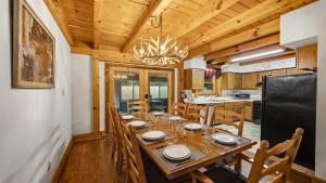 a dining room with a table and a kitchen at Hillside Hideaway in Sevierville