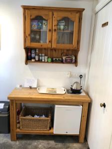 a kitchen with a wooden counter top and a sink at Samphire in Padstow +22 photos