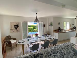 a kitchen and dining room with a table and chairs at tyklan in Bénodet +45 photos