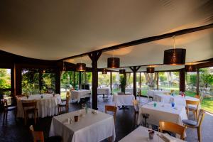 a dining room with white tables and chairs at Romantic Hotel Furno in San Francesco al Campo