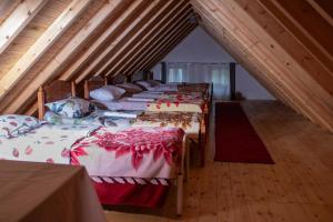 a group of four beds in a attic at Bujtina Mitaj in Vermosh +22 photos