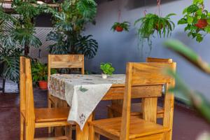 a wooden table with two chairs and a tablecloth on it at Wenyeji Inn Hotel Moshi in Moshi