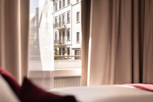 a room with a window with a view of a building at Hotel St.Gotthard in Zurich