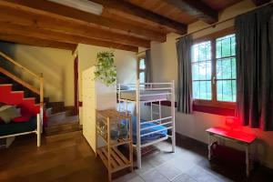 a room with two bunk beds and a staircase at Sallobante Aterpetxea - Casa in Mechicas