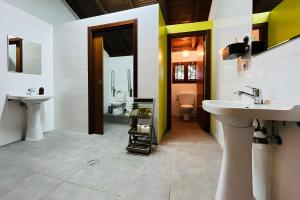 a bathroom with two sinks and a toilet at Sallobante Aterpetxea - Casa in Mechicas +16 photos