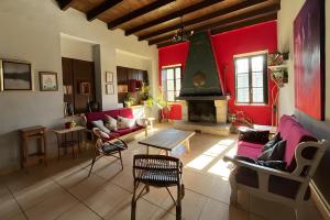 a living room with red walls and a fireplace at Sallobante Aterpetxea - Casa in Mechicas