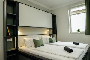 a bedroom with a large bed with a large headboard at KRUSHPOINT Krušnohorský hotel in Horní Blatná