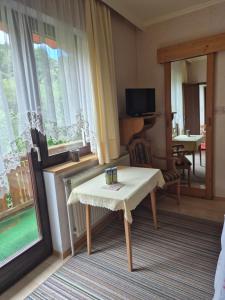 a room with a table and a living room at Landhaus Ingrid in Loich