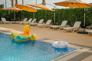 a pool with a rubber duck and a raft in the water at Era Palace Gonio in Kvariati +61 photos